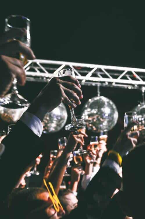 crowd celebrates new years eve countdown with a champagne toast