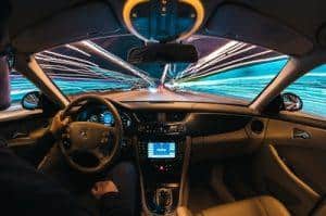 Dashboard view of car on busy street with speeding cars