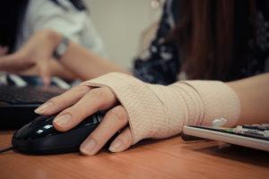 Hands at keyboard with wrapped wrist