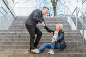 man helping older woman up