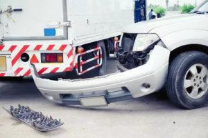 A car damaged after colliding with a truck