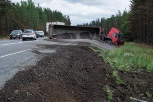 Truck transporting cargo rolled into a ditch