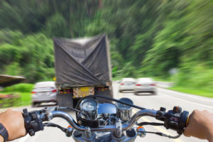 driver about to lose control of his motorcycle in traffic