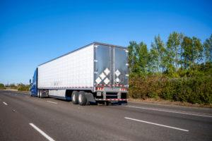 semi-truck driving down the road