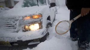 truck lying sideways in the snow after an accident