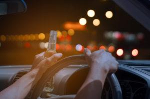 driver drinks alcohol behind the wheel