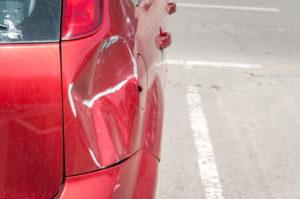 car damaged after fender bender in parking lot