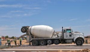 construction workers pour concrete