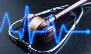 ekg reading over gavel and stethoscope