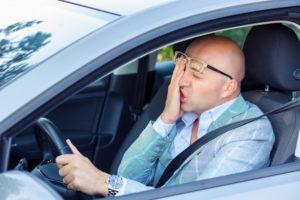 exhausted motorist behind the wheel