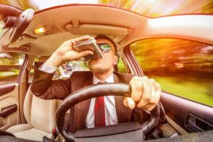 motorist drinking from flask while driving