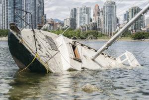 sinking boat abandoned by passengers