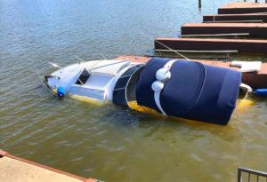 sinking pleasure boat at its mooring