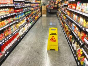 wet floor sign on grocery store aisle