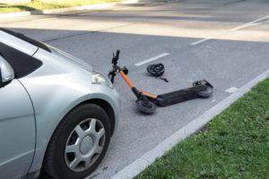 car and scooter in road