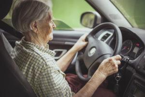 elderly car driver on a busy road