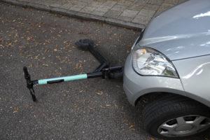 green scooter under a car