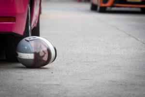 helmet by car tire