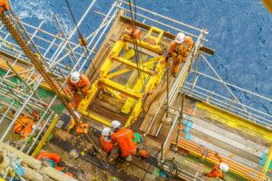 offshore workers in full personal protective equipment