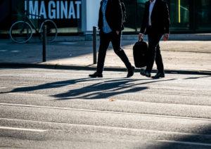 two businessmen crossing the street