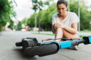 woman on the ground after a scooter accident