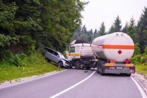 truck-slides-across-the-road-and-hits-car